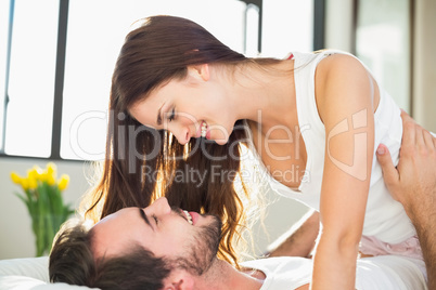 Young couple having fun in bed