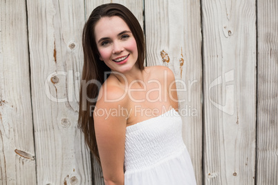 Pretty brunette posing in white dress