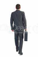 Businessman walking with his briefcase