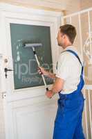 Handyman cleaning the window with squeegees