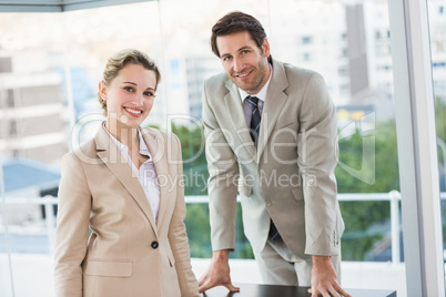 Business people posing and smiling at camera Business people posing and smiling at camera