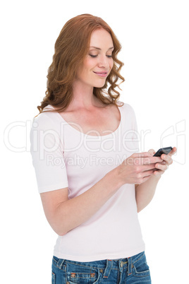 Pretty redhead sending text message