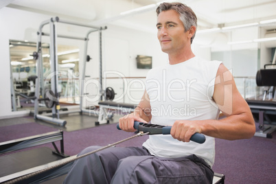 Fit man working out on rowing machine