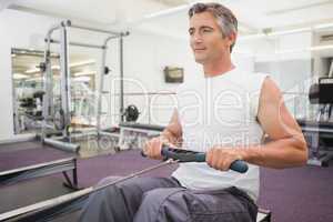 Fit man working out on rowing machine