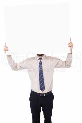 Businessman showing white poster in front of his head