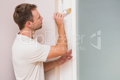 Painter painting the door white