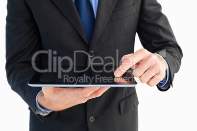 Close up of finger from businessman touching tablet