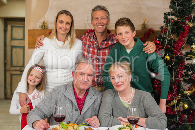 Happy extended family looking at camera at christmas time