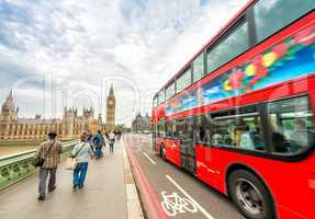 London. Double Decker bus speeding up on Westminster Bridge