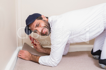 Handyman laying down a carpet