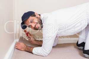 Handyman laying down a carpet