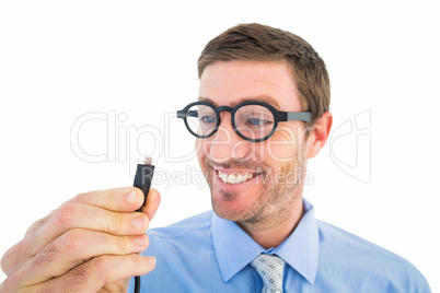 Geeky businessman holding a cable