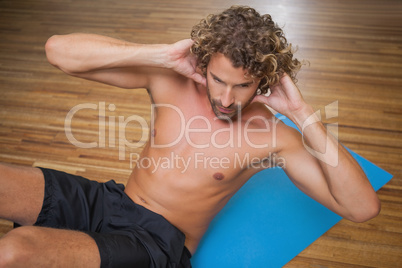 Shirtless man doing push ups in gym Shirtless man doing push ups in gym