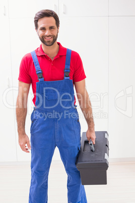 Construction worker holding tool box