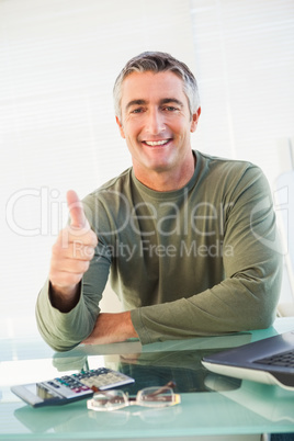 Positive casual man with his thumb up