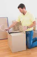 Man open a moving box at home