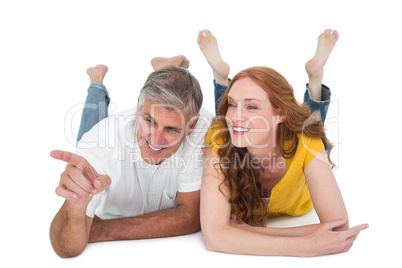 Casual couple lying on floor