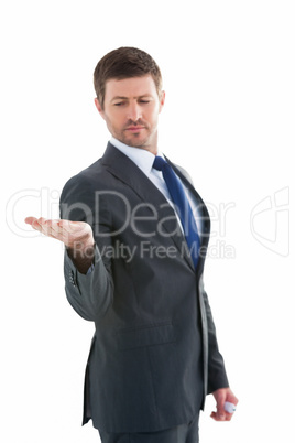 Businessman holding hand out in presentation