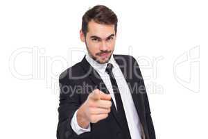 Smart businessman in suit pointing at camera