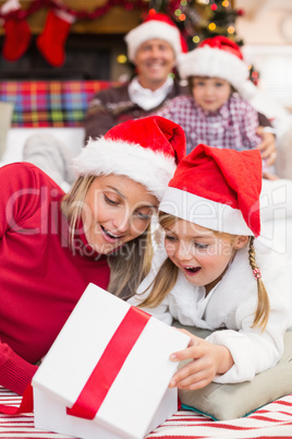 Surprised mother and daughter opening a christmas gift