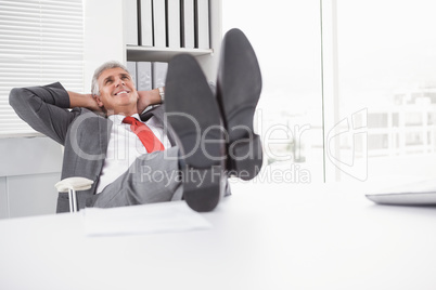 Relaxed businessman with his feet up