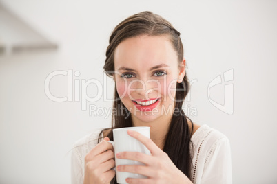 Pretty brunette holding a mug