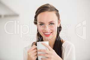 Pretty brunette holding a mug