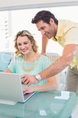 Casual business team working together with laptop