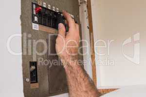 Electrician working on the fuse box