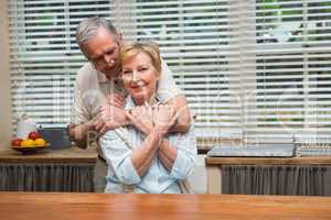 Senior couple smiling at the camera together