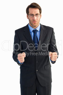 Angry businessman with closed fists looking at camera