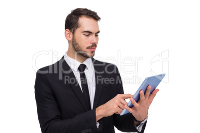 Cheerful businessman touching digital tablet