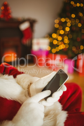 Santa claus using a smartphone at christmas