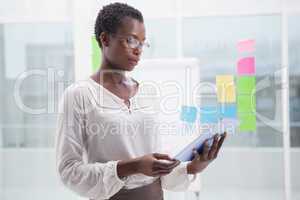 Businesswoman with glasses using tablet