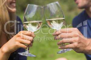 Cute couple toasting with white wine