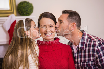 Daughter with her father kissing her mother