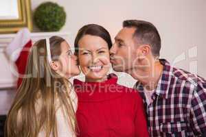 Daughter with her father kissing her mother