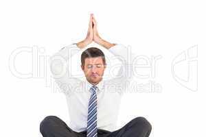 Businessman meditating in lotus pose