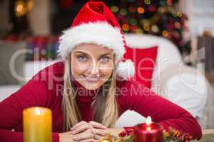 Portrait of a smiling blonde in hat at christmas