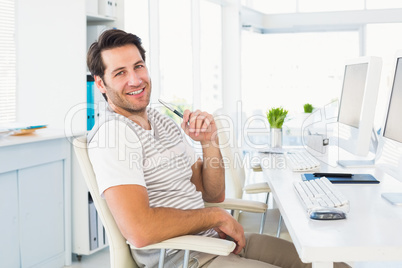 Casual young man with computer in a bright office