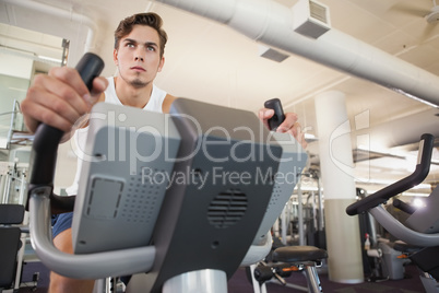 Fit man working out on the exercise bike