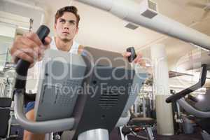 Fit man working out on the exercise bike