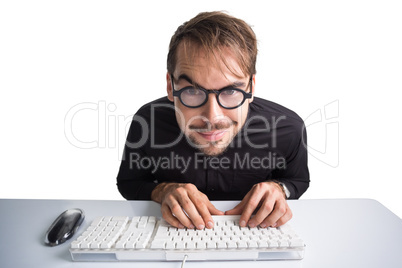 Excited businessman using computer and wearing glasses