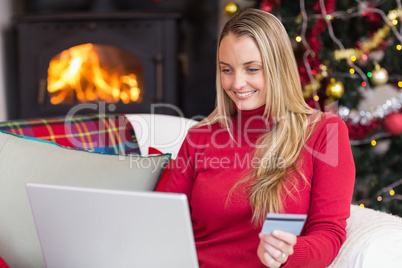 Woman doing online shopping with laptop and credit card