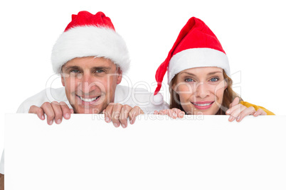 Festive couple showing a poster