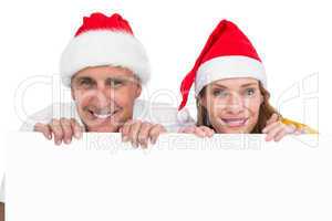 Festive couple showing a poster