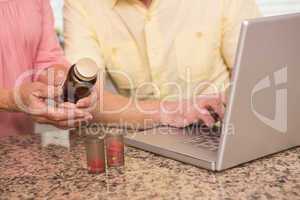 Senior couple looking up medication online