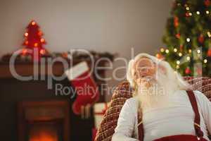Father christmas resting on the armchair