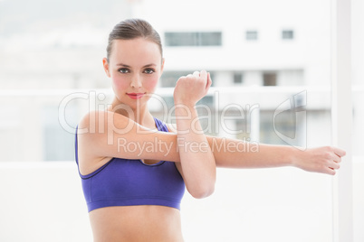 Fit brunette stretching her arms