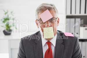 Confused businessman with sticky notes on head